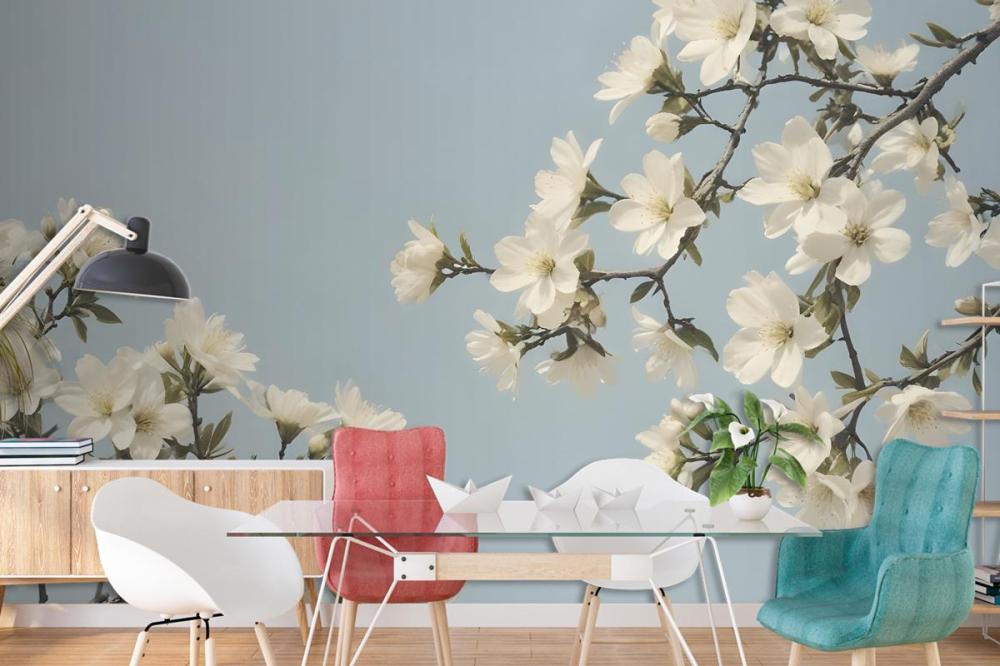 White Flowers Blooming On Tree Branches Against A Pale Blue Sky Wallpaper Mural